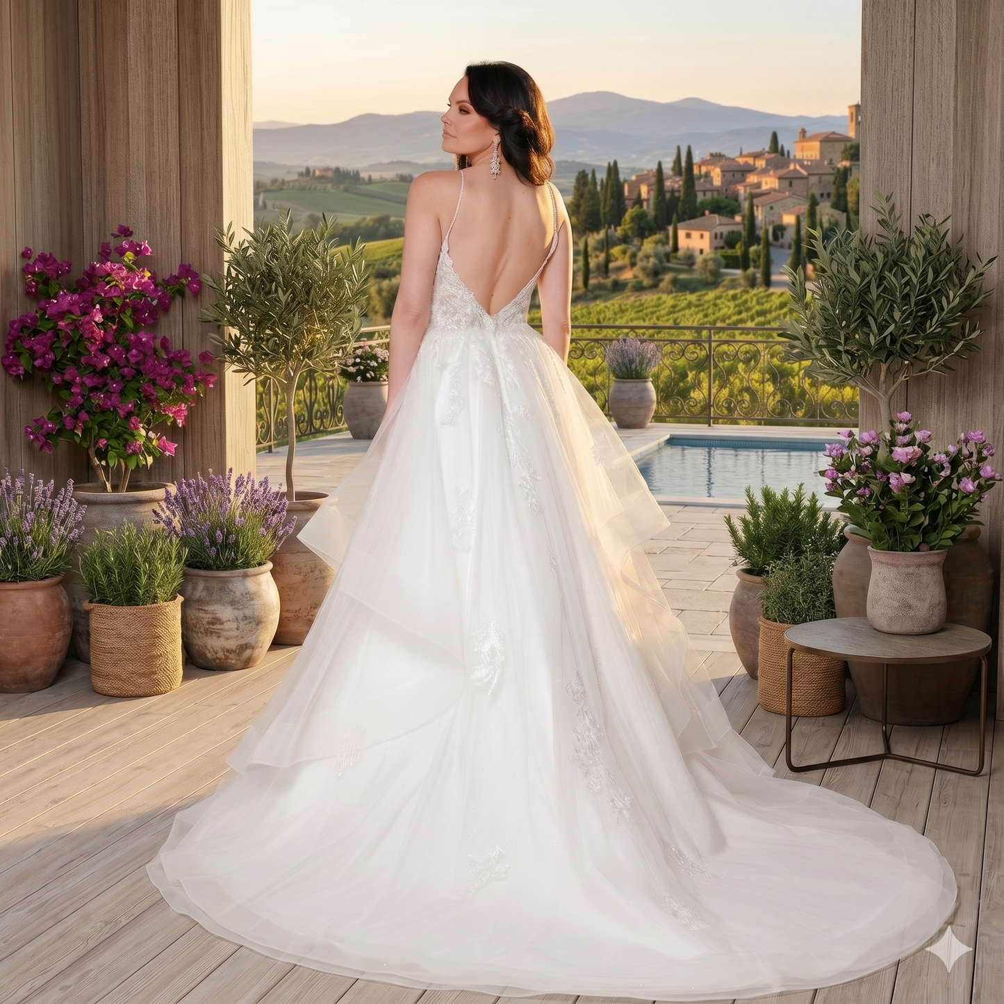 Robe de mariée princesse blanche Arielle J. style 6115 avec corsage en dentelle florale, dos nu et jupe en tulle sur une terrasse de mariage luxueuse.